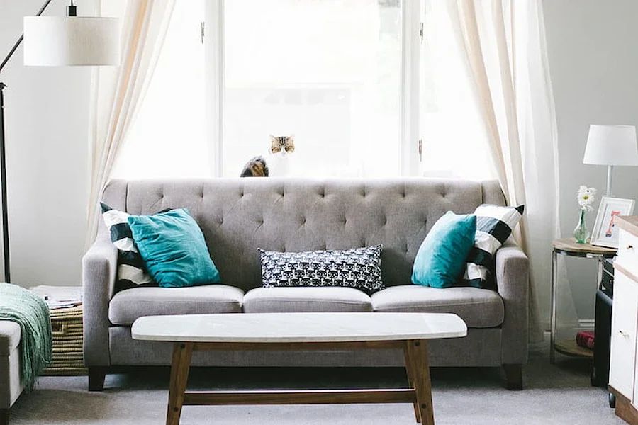Grey sofa with blue pillows for a coastal farmhouse style