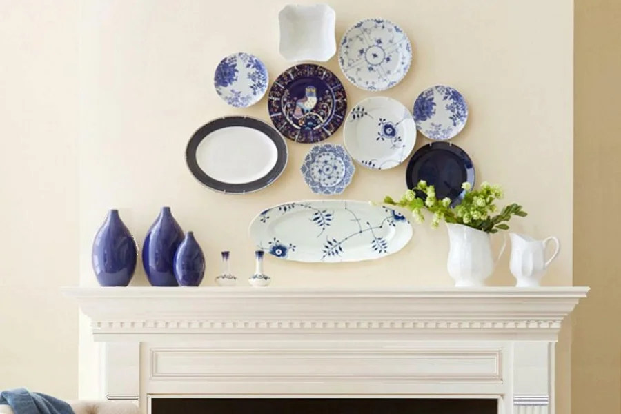 ceramic plates hung on wall above the white mantel