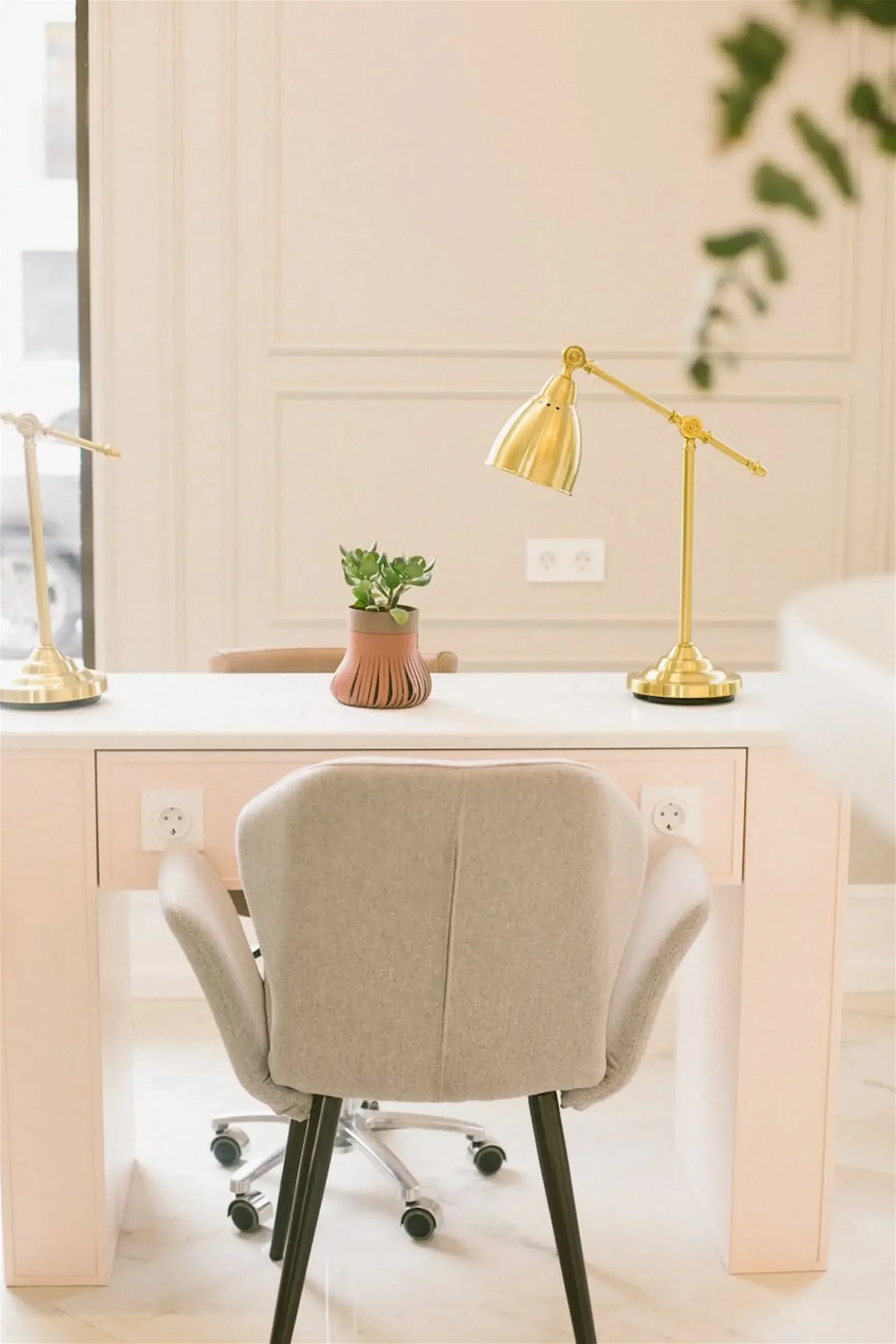 pastel pink farmhouse office decor room with a table and a pink chair