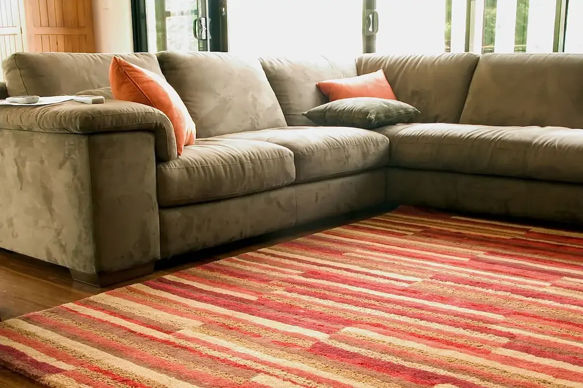 orange rug and gray sofa